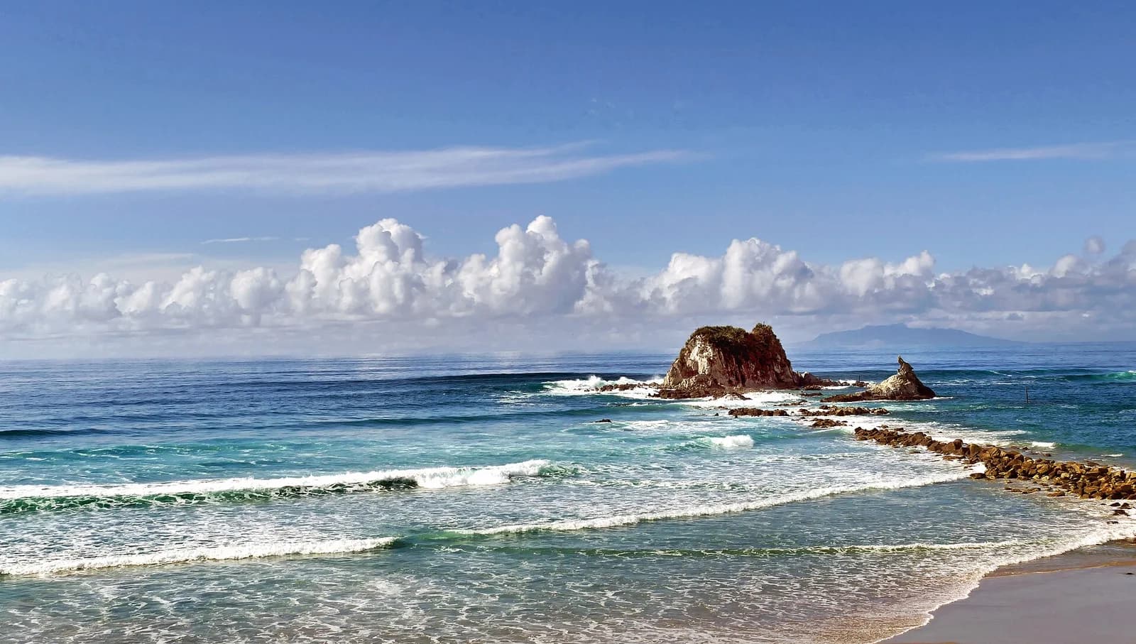 Mangawhai Heads Beach in Northland; representative setting, not a photograph of the named golf course