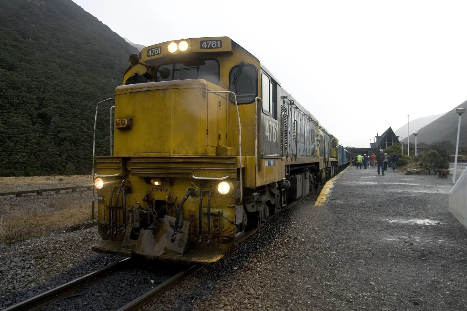 The silver TranzAlpine train stopped at Arthur’s Pass station beneath the Southern Alps
