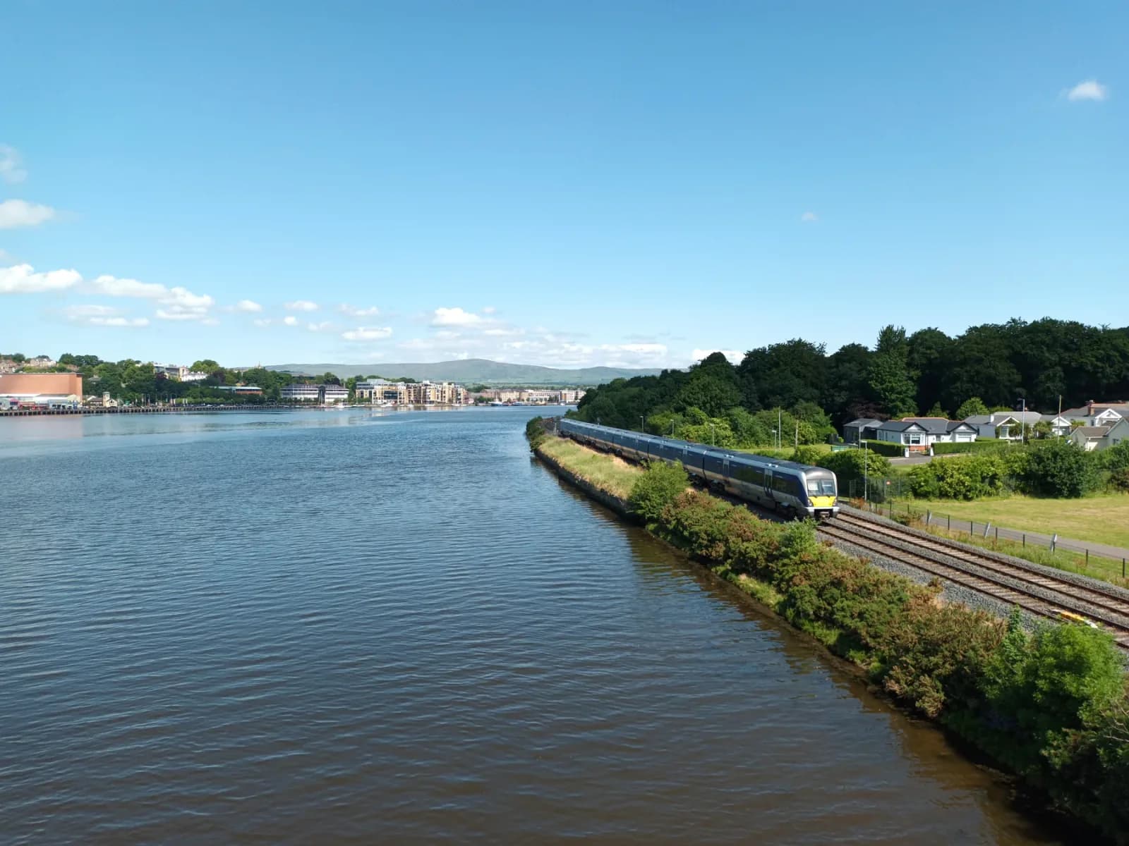 Railway tracks curving beside the River Foyle toward Derry-Londonderry
