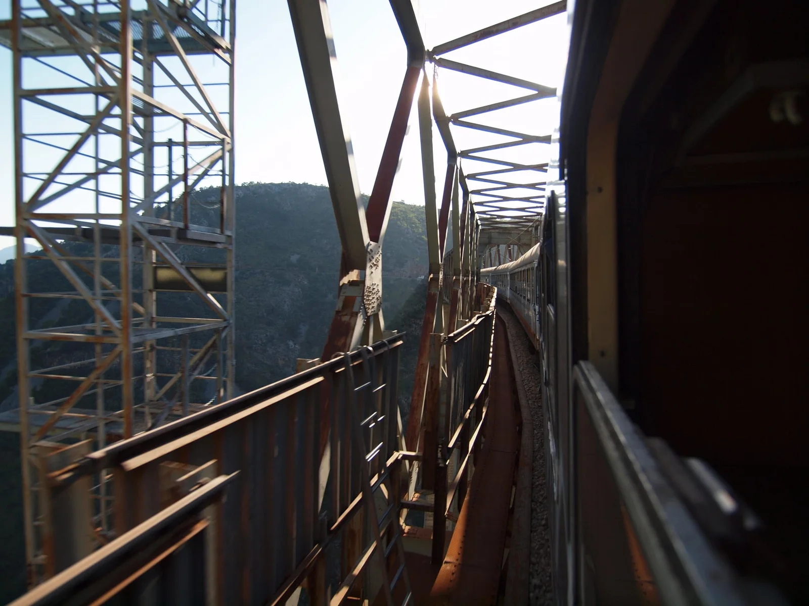 A passenger train curving across the Mala Rijeka Viaduct in Montenegro