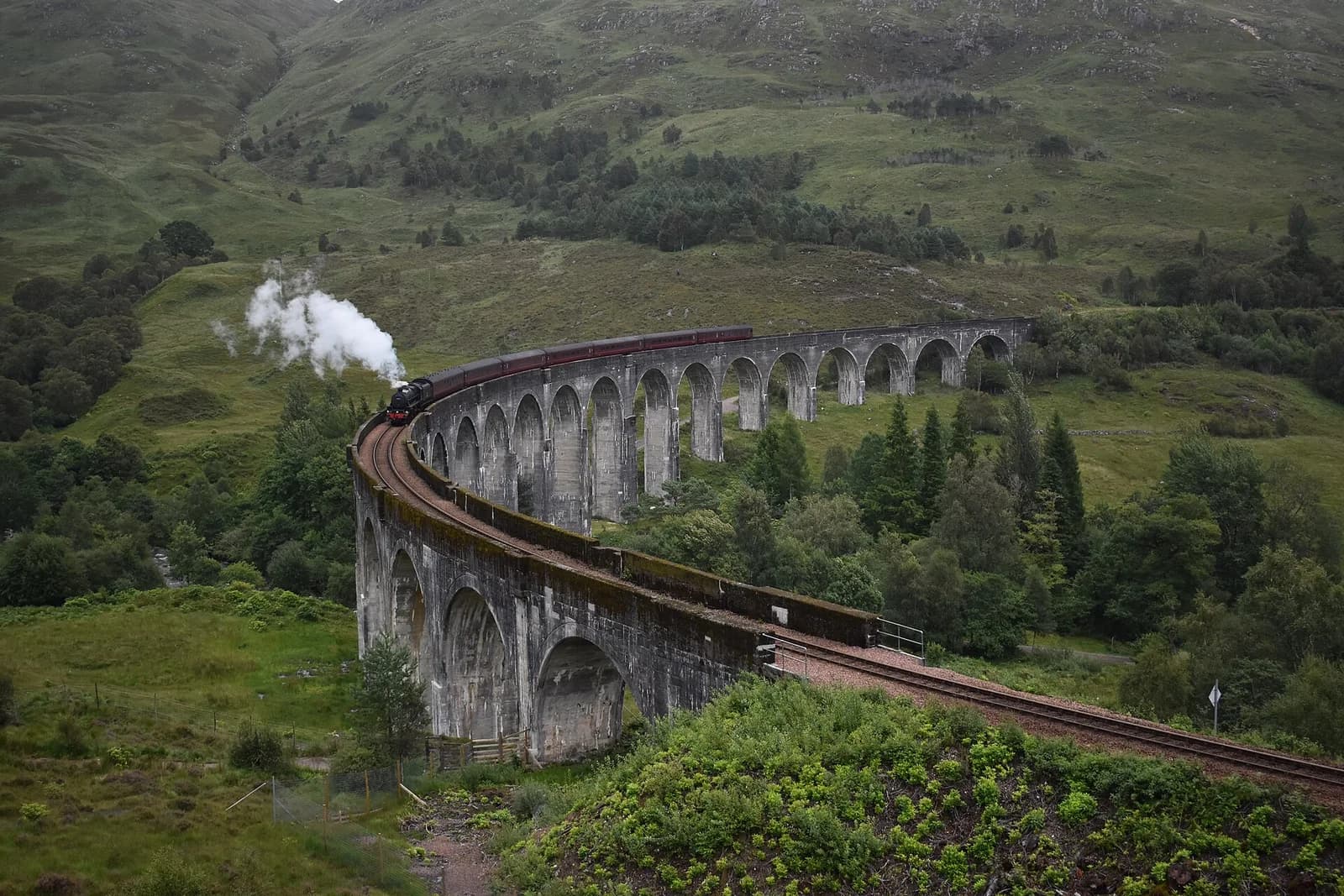 The Jacobite Steam Train crossing Glenfinnan Viaduct in the Scottish Highlands