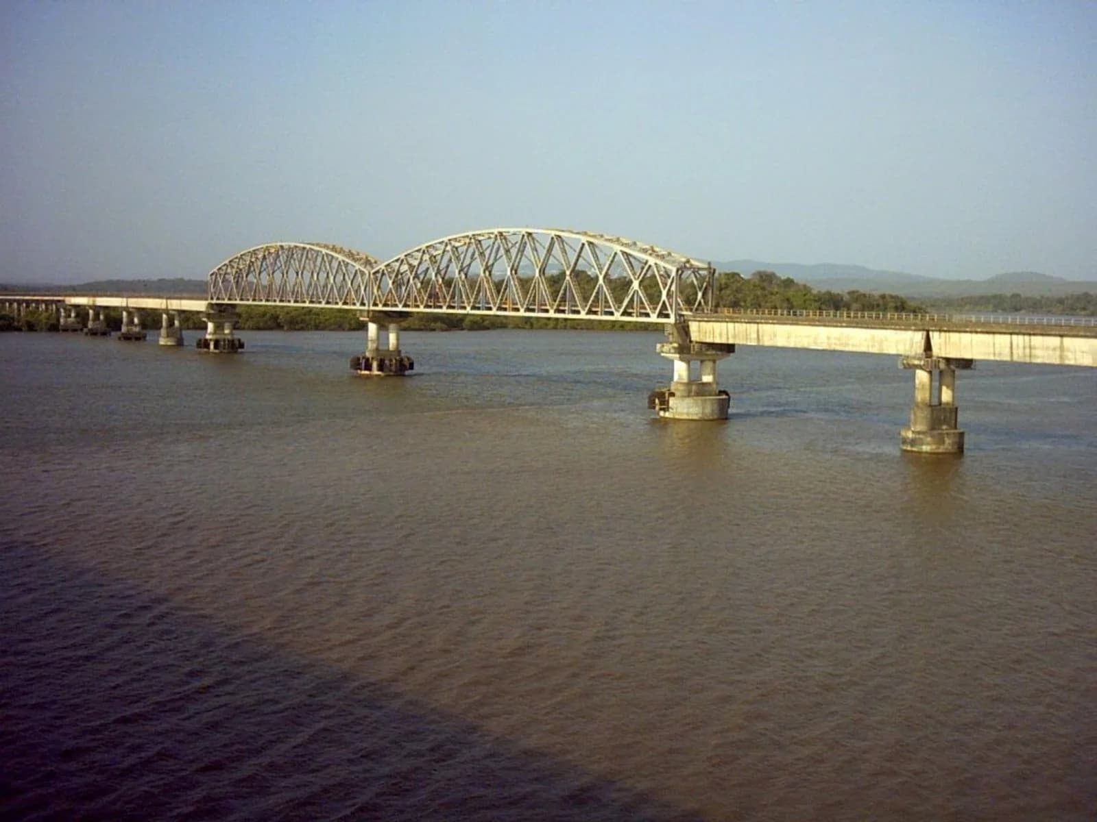 A railway bridge crossing a green valley on the Konkan Railway
