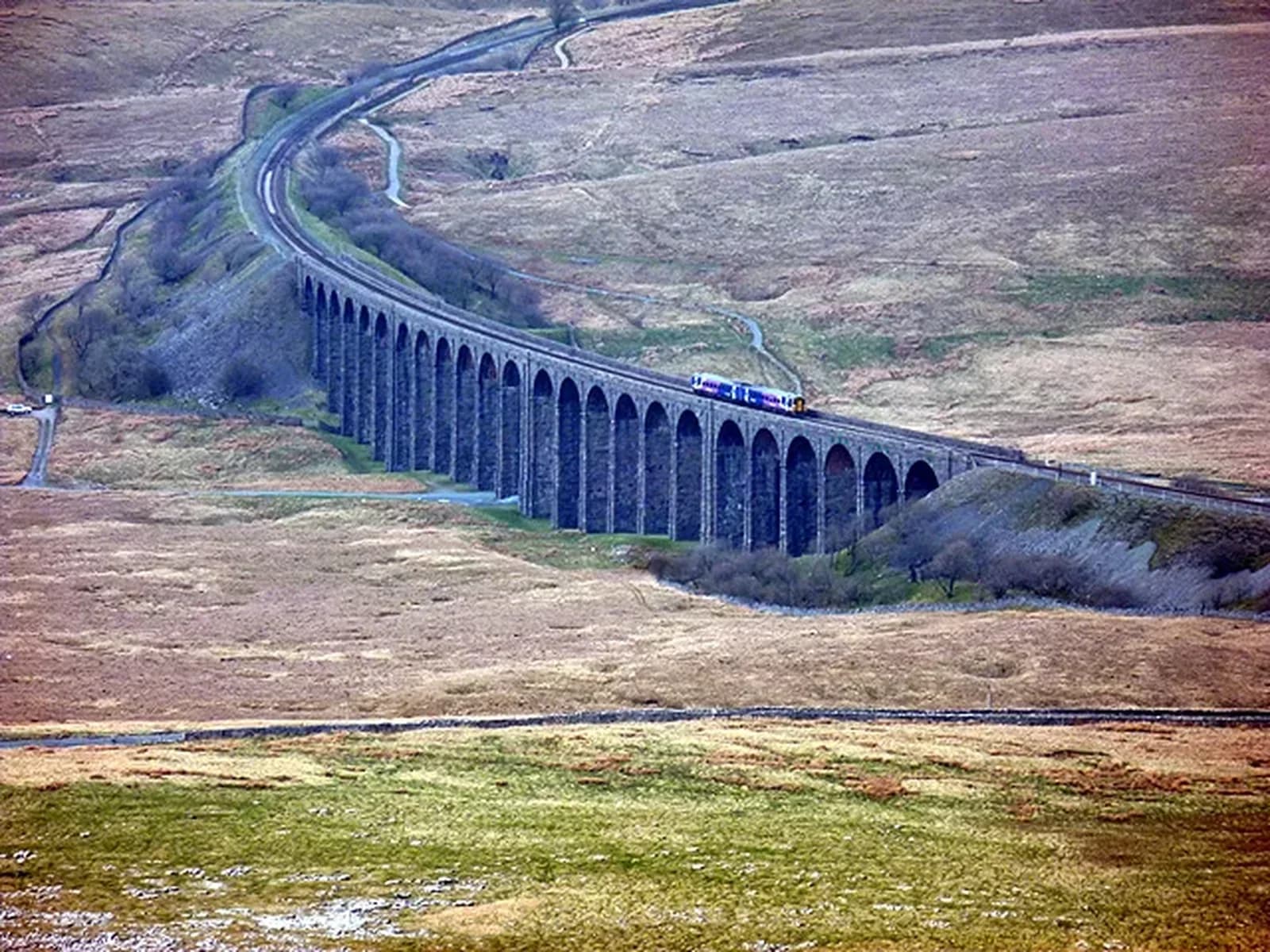 A Carlisle-bound passenger train crossing Ribblehead Viaduct